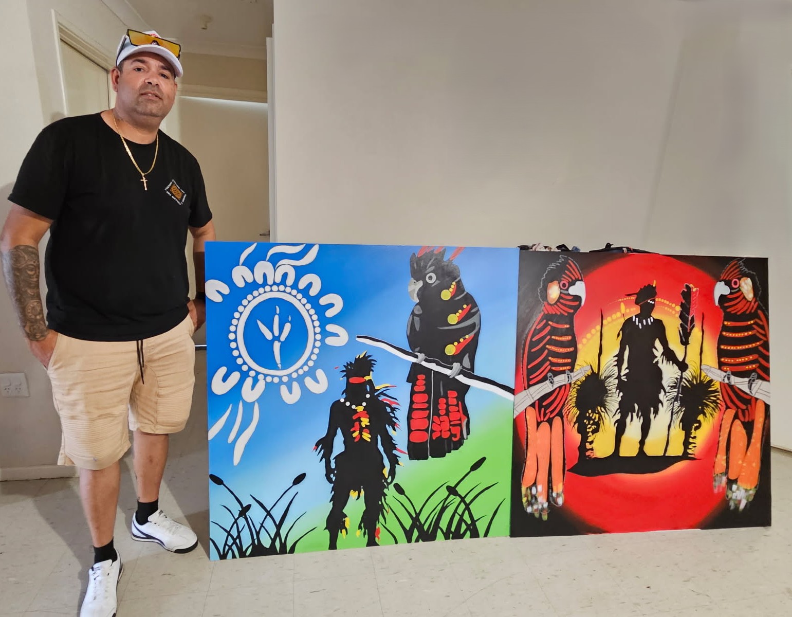 Jason Bropho holding his Kaarakin artwork