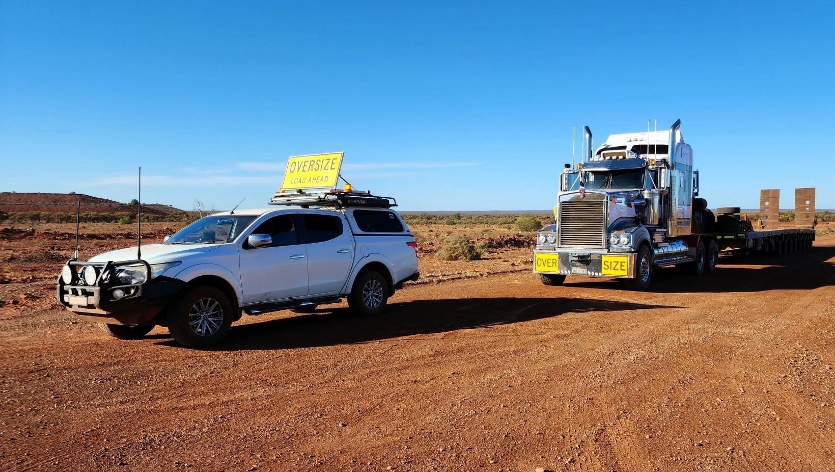 Pilot Vehicle parked in front of a heavy vehicle