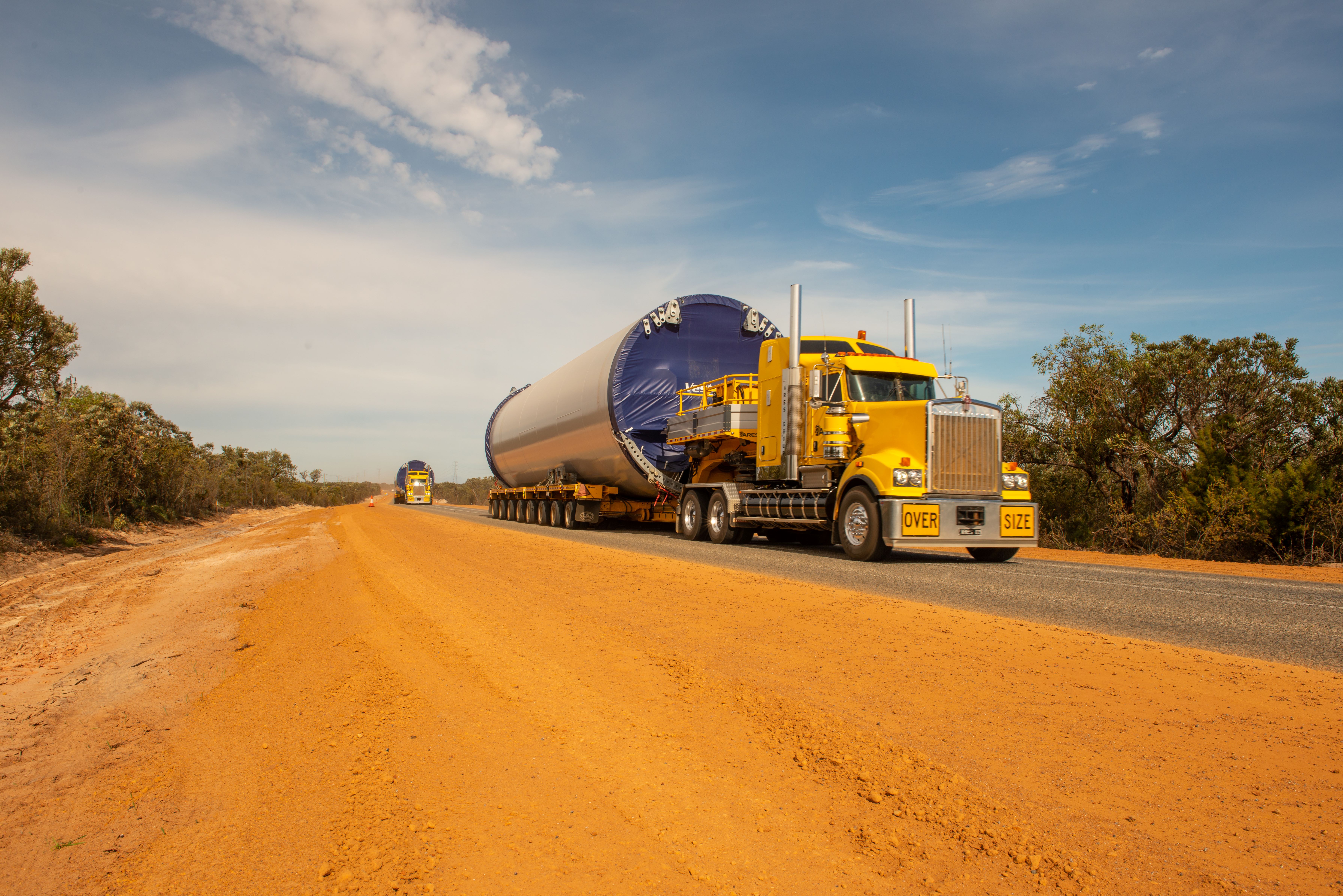 Oversize and Overmass Heavy Vehicle driving on a road with a large tank as the load