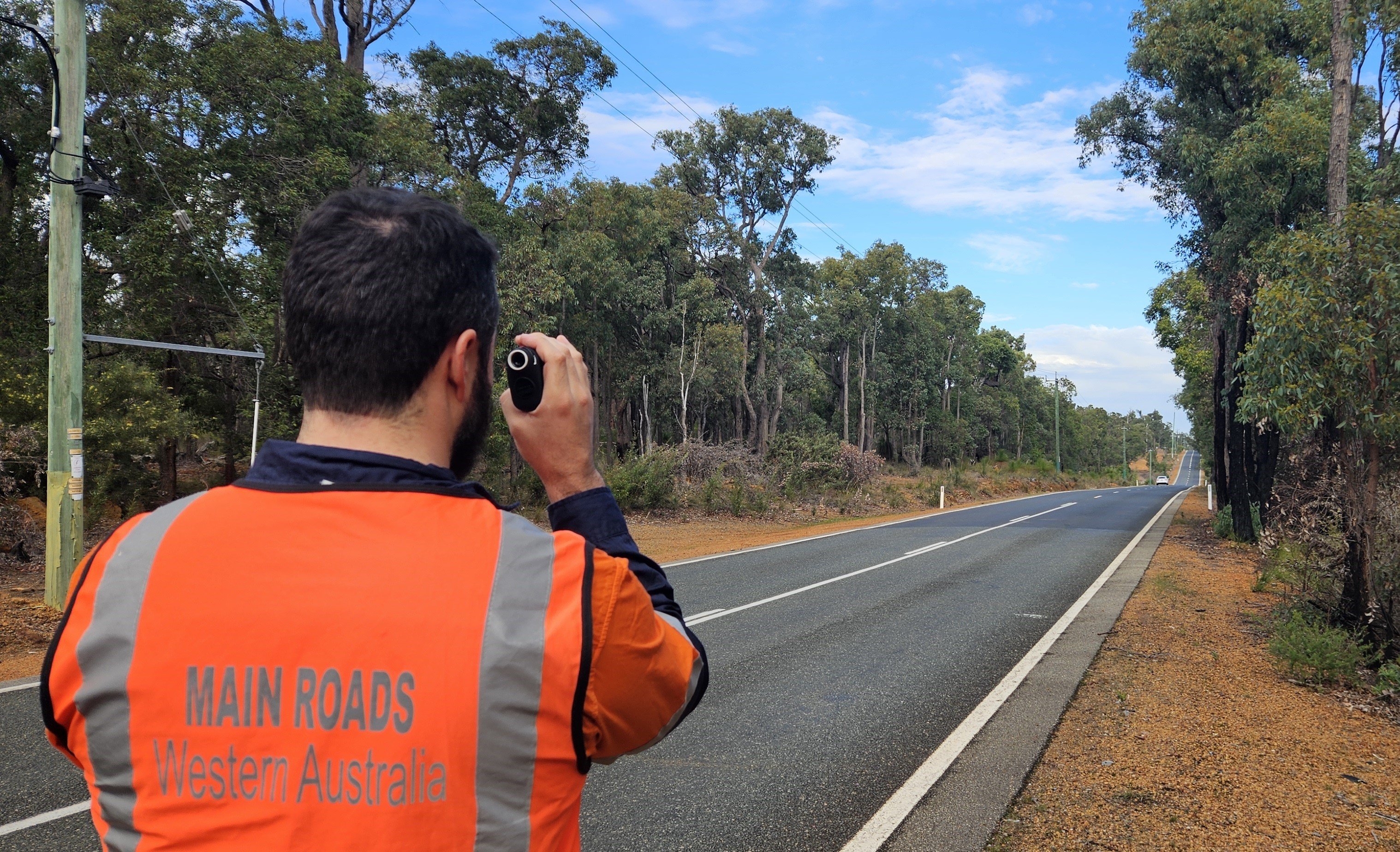 Main Roads worker carrying out a route assessment for heavy vehicles