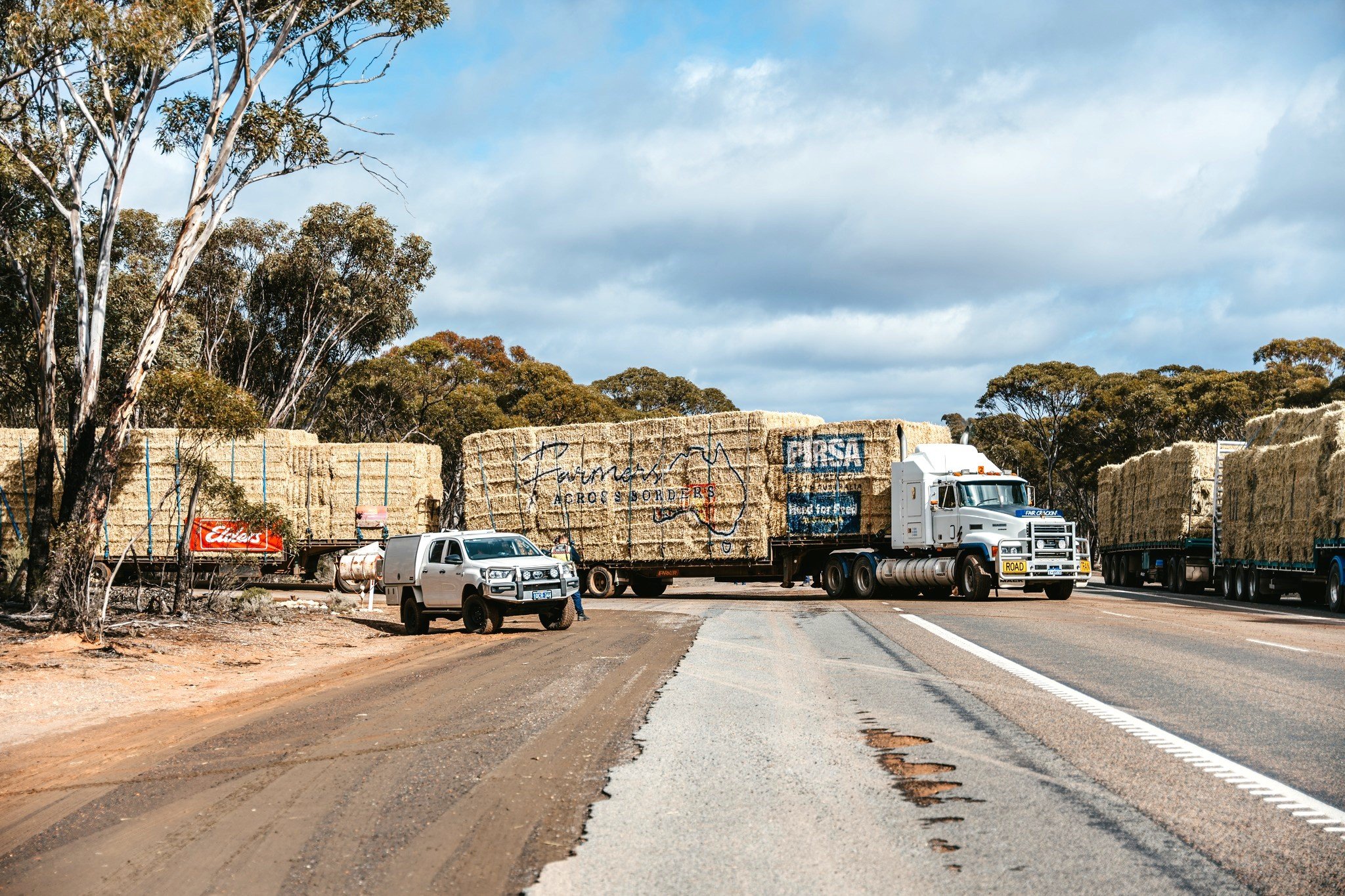 Road Train carrying a Load of Hay entering a road