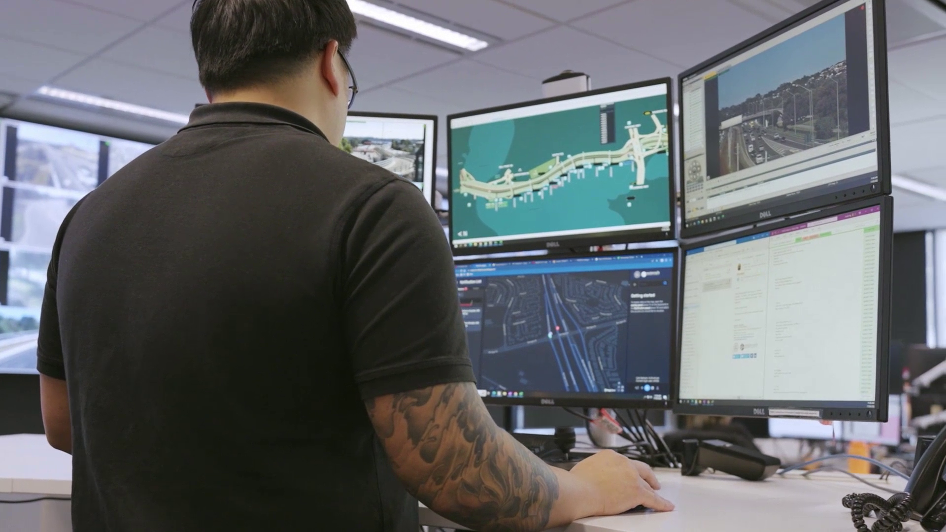 Worker at his desk in front of computer screes