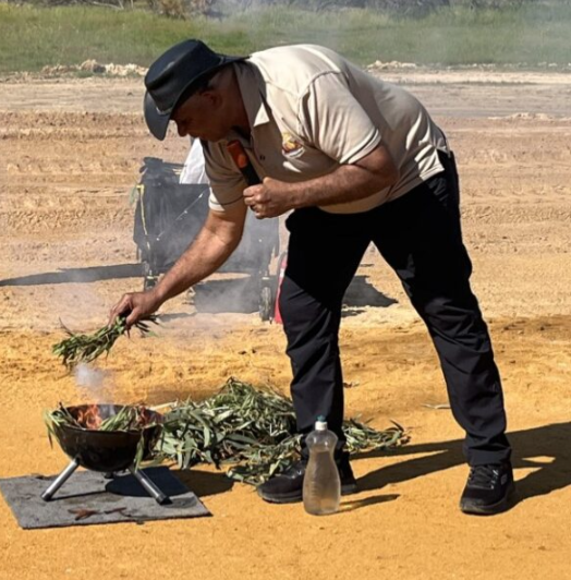 Whadjuk Elder, uncle Nick Abraham leads a smoking ceremony at the Reid Highway Interchanges project site.
