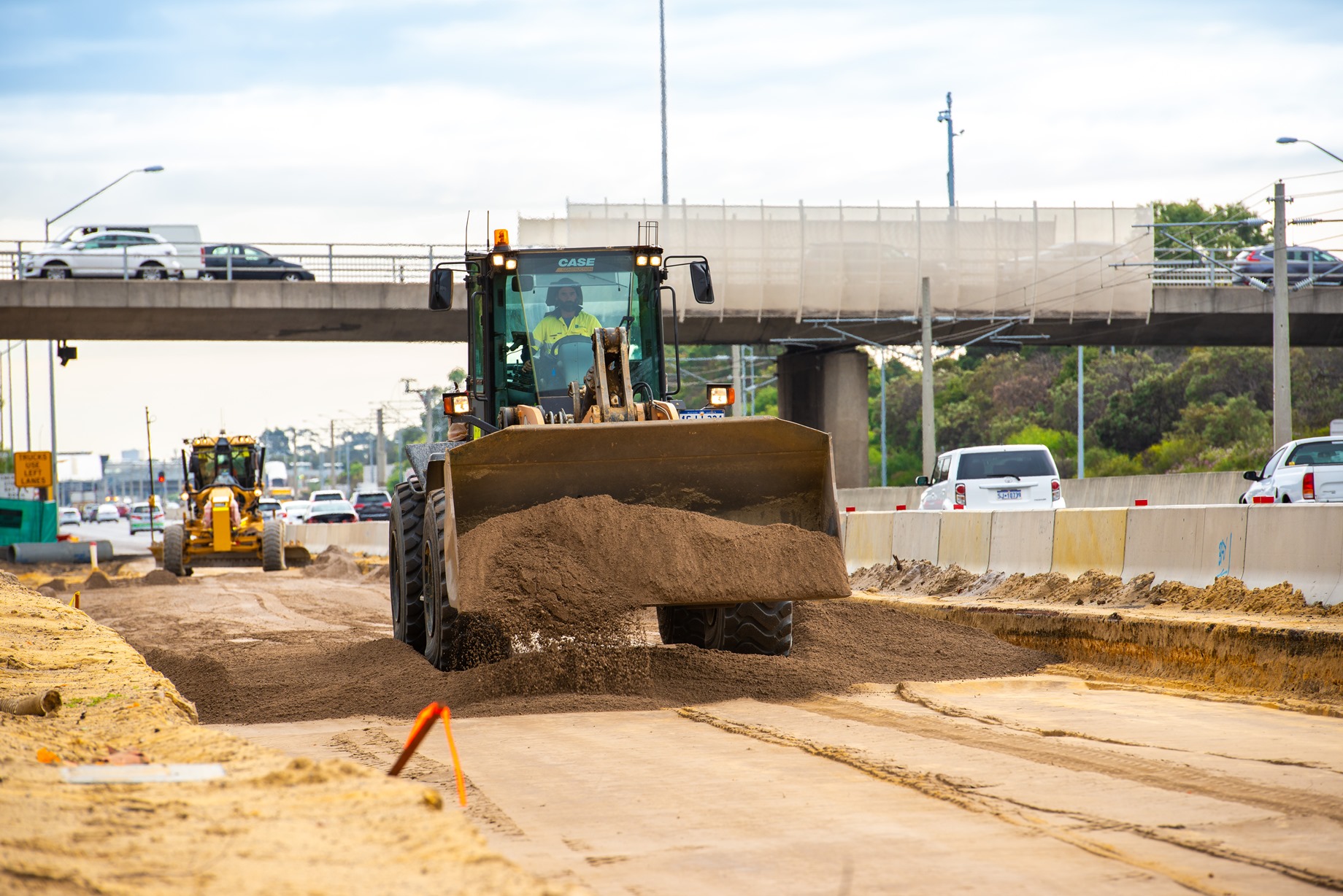 Construction vehicles moving materials