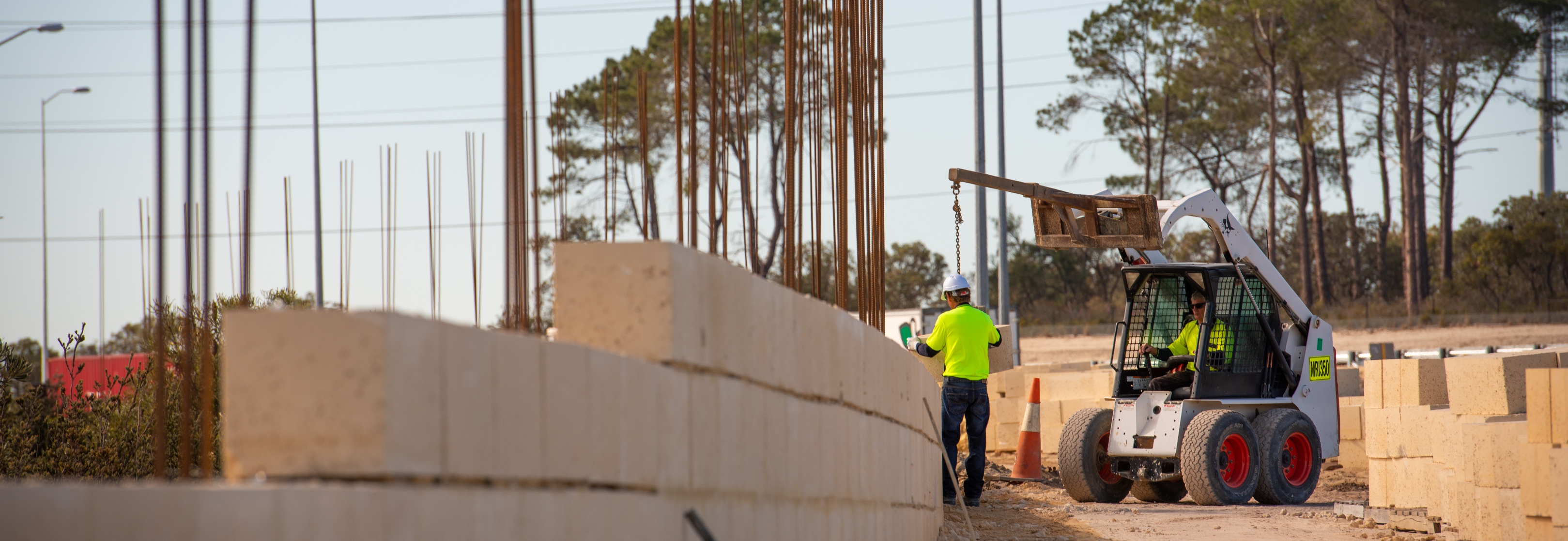 Workers building a limestone wall