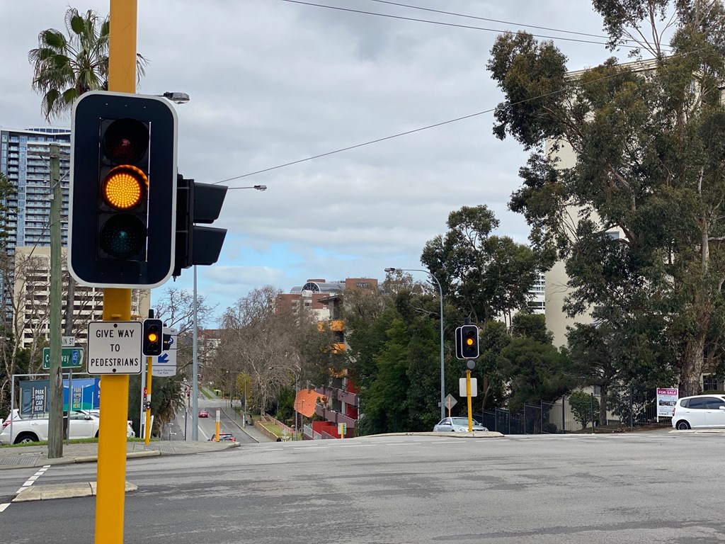 Flashing Orange traffic lights at an intersection
