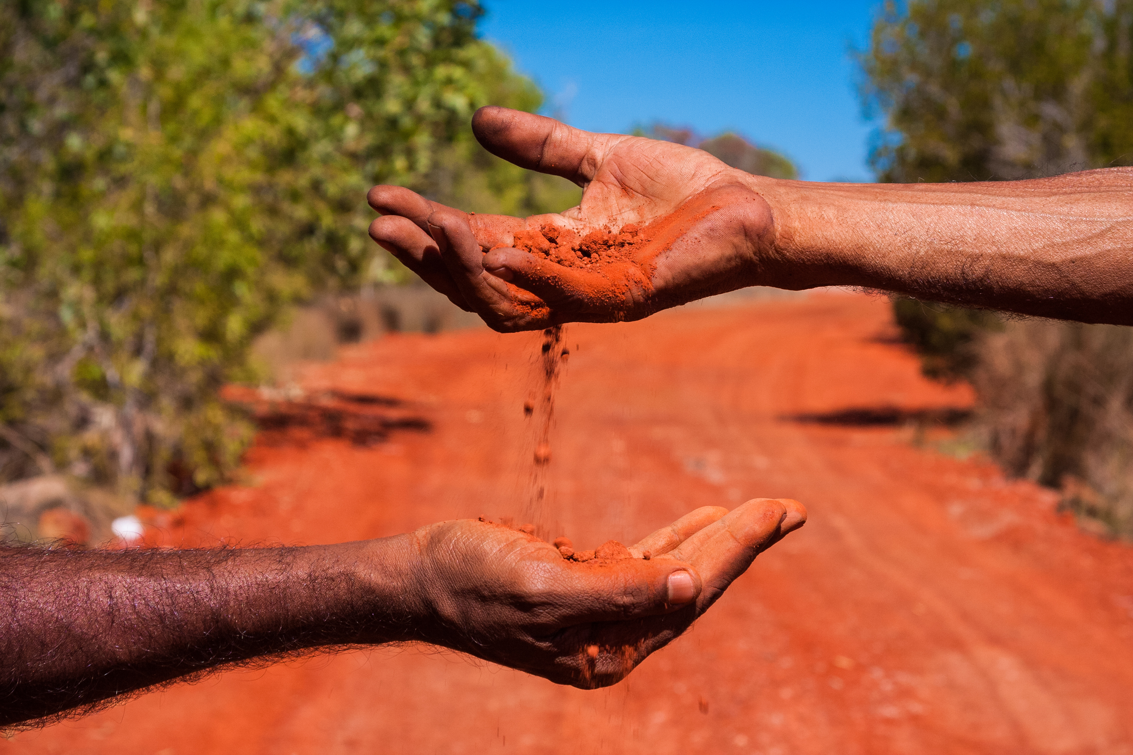 Moving red dust in hands