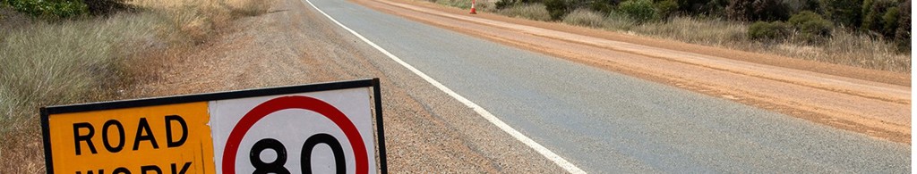'Road Work Ahead - 80 Km h' speed sign on the side of the road