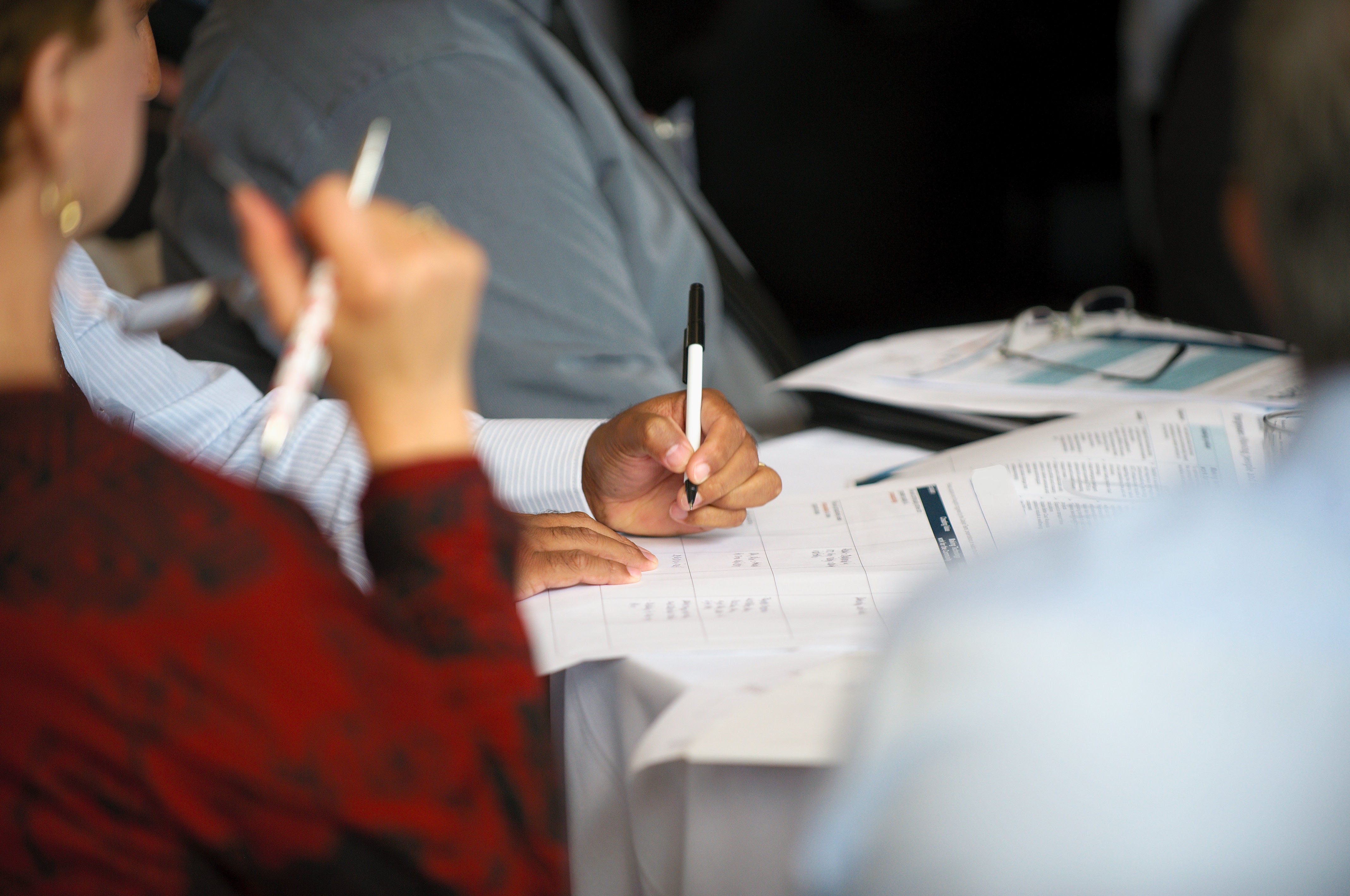 People at a table taking notes