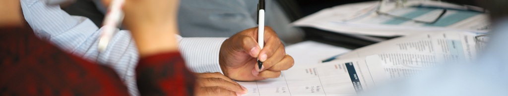 People at a table taking notes