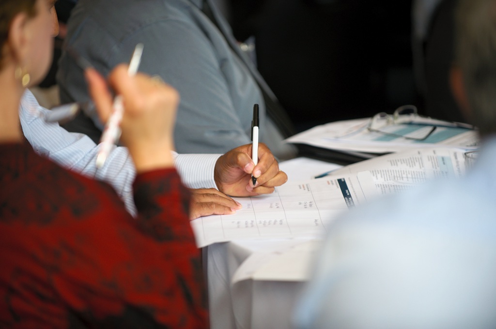 People at a table taking notes