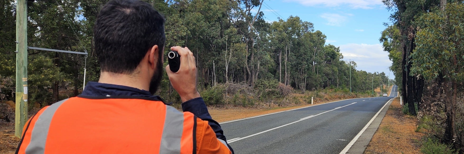 Main Roads worker carrying out a route assessment for heavy vehicles