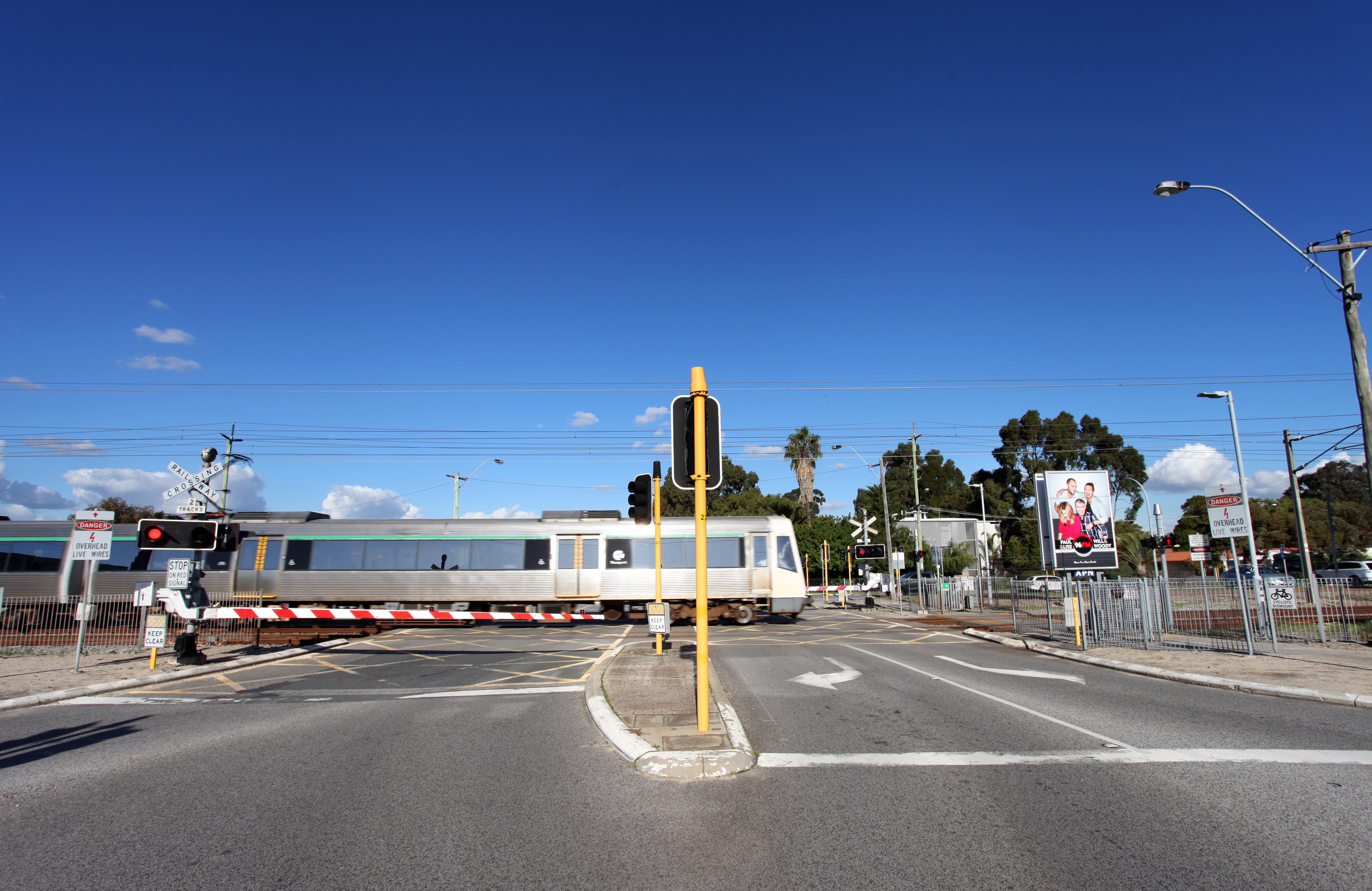 Level crossing down with train passing by