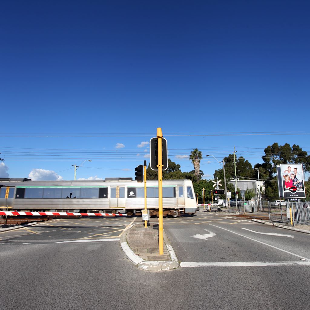 Level crossing down with train passing by