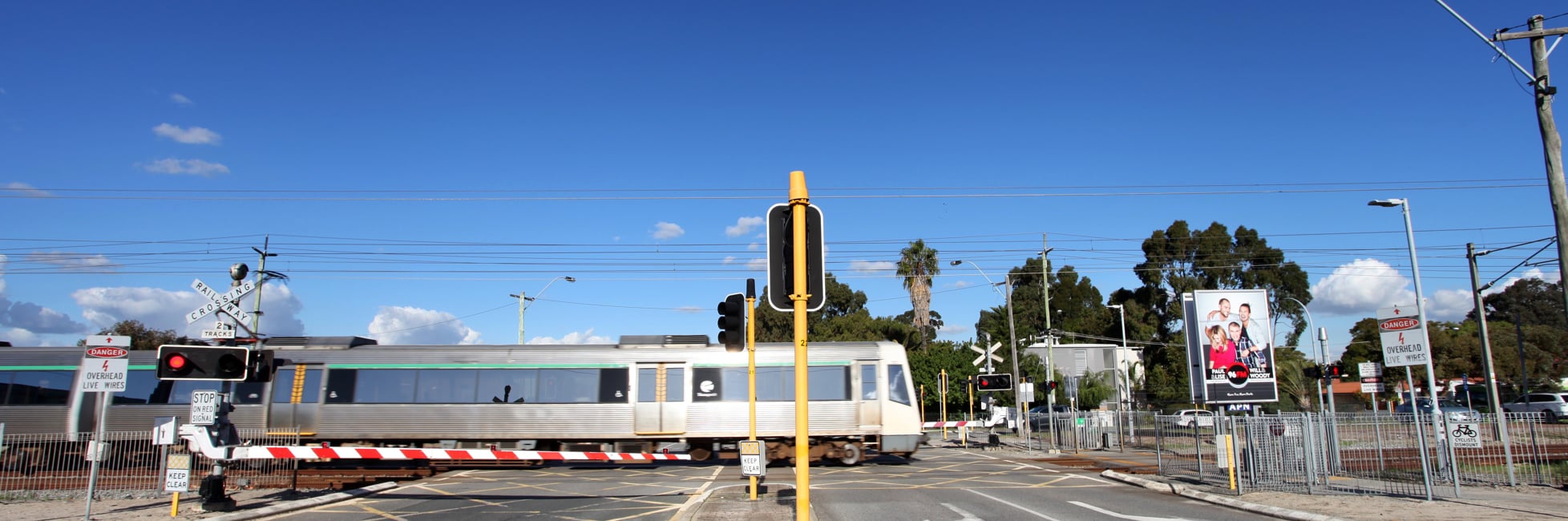 Level crossing down with train passing by