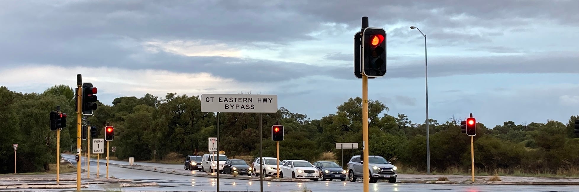 Traffic waiting at traffic lights with a Great Eastern Highway Bypass sign