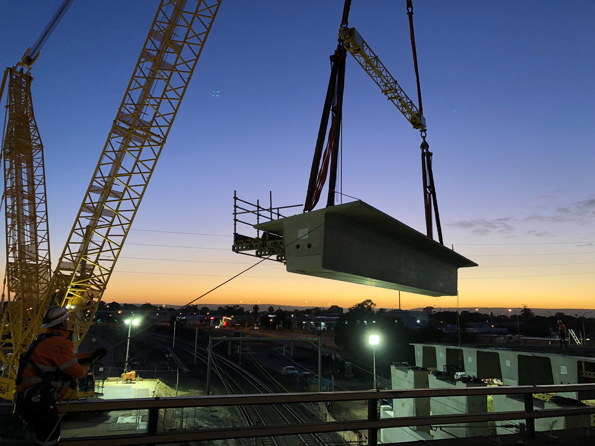 Crane lifting a bridge beam into place