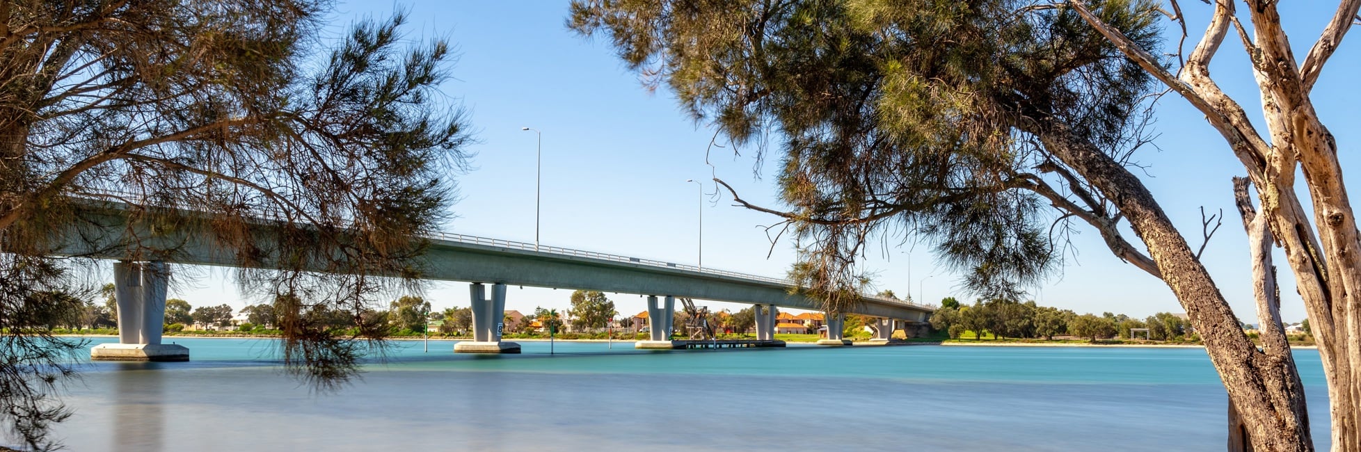 Mandurah Bridge over river surrounded by trees
