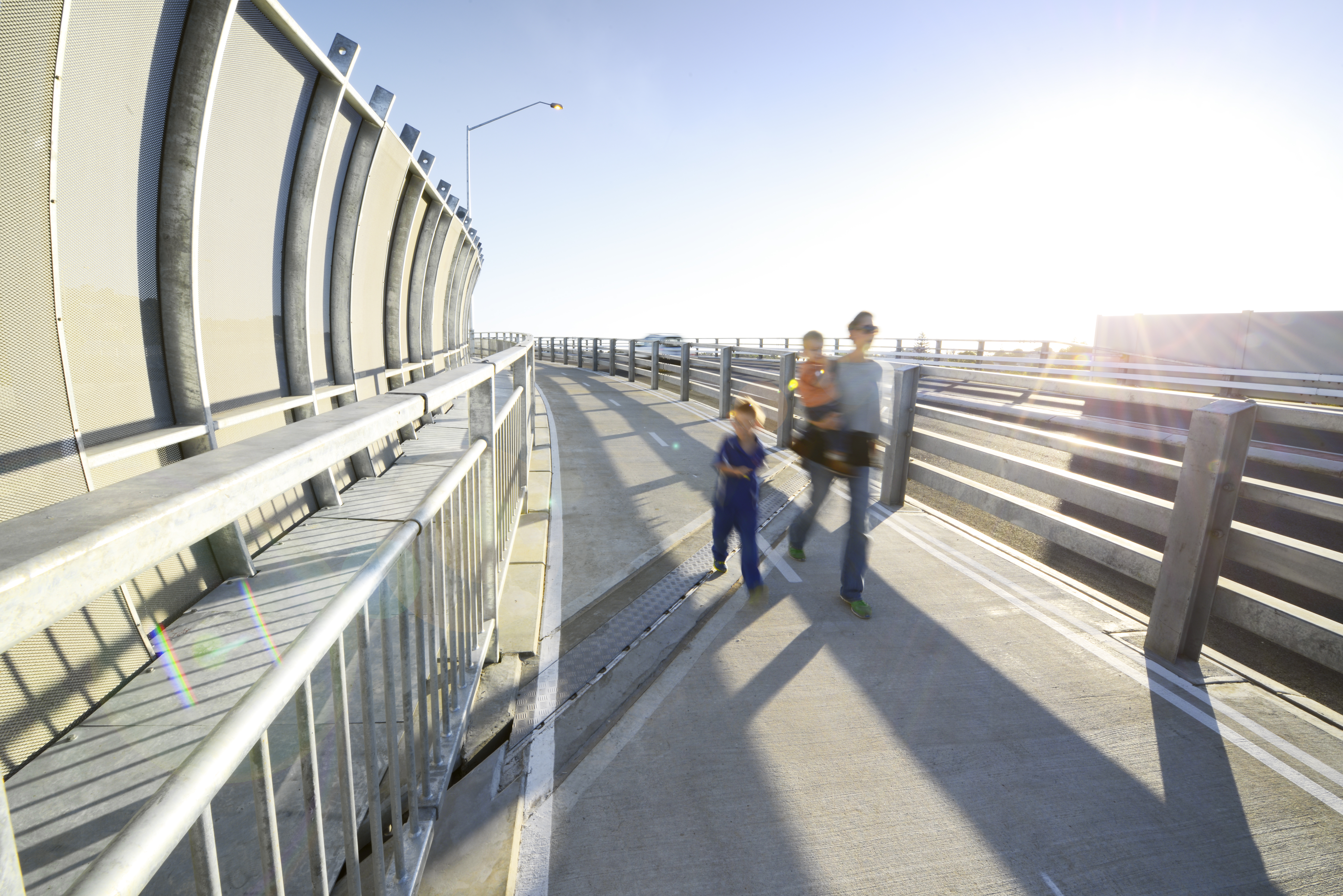 Person walking on path with two children